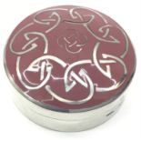 A Scottish solid silver and enamel pill pot with Celtic design on the top and Scottish hallmarks.