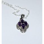 A Diamond and Amethyst pendant necklace set on silver chain.