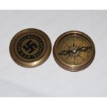 A brass military style compass with swastika to the lid.