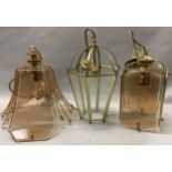 Three brass and glass pendant style ceiling lights
