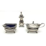 A three piece solid silver cruet set with blue liners and silver spoons.
