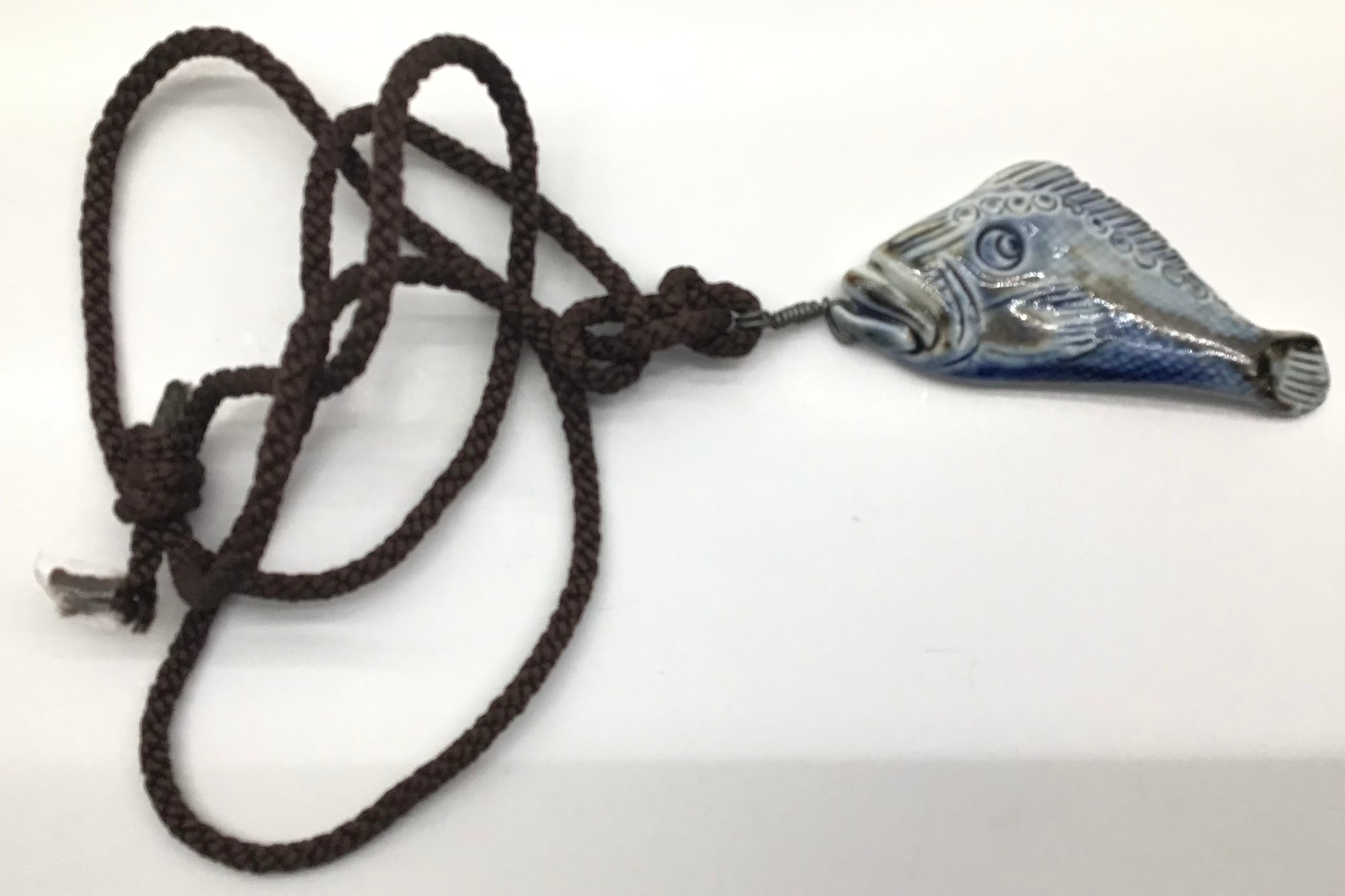 Poole Pottery interest Guy Sydenham pendant depicting a fish marked to reverse.