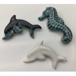 Poole Pottery blue dolphin brooch together with a white dolphin brooch & a blue seahorse brooch (3)