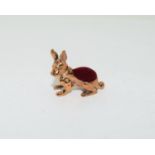 A brass rabbit pin cushion.
