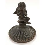Bronzed inkwell lid/paperweight depicting a cherub.