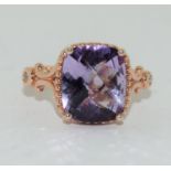 a 925 and rose gold gilt ring with large purple stone to centre. Size O (D9)