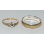 A gold wedding band together with a delicate gold ring with stones. (23 & 25)