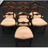 Set of seven dark mahogany dining chairs with carved decoration to the backs and fluted legs.