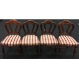 Set of four Victorian mahogany dining chairs with beige/red/gold striped fabric upholstered seats.