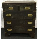 A military campaign chest of two over three drawers,brushing slide and brass fitments 62x31x73cm.