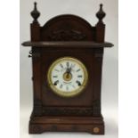 A Fattorini & Son oak clock with alarm.