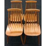 Set of four teak mid century style stick back dining chairs .