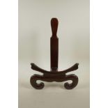 A Chinese carved hardwood charger stand, 16½" high