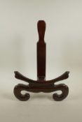 A Chinese carved hardwood charger stand, 16½" high