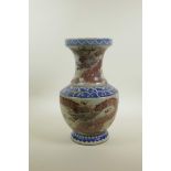 A Chinese blue and white porcelain vase of waisted form with iron red dragon and flaming pearl
