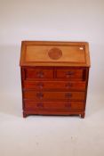 A Chinese hardwood bureau with fall front over two and three drawers, raised on shaped supports, 36"