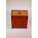 A Chinese hardwood bureau with fall front over two and three drawers, raised on shaped supports, 36"