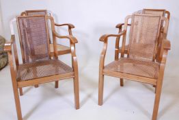 A set of four Art Deco walnut open armchairs, with carved backs and seats