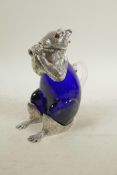A silver plated and blue glass claret jug in the form of a squirrel, 7" high