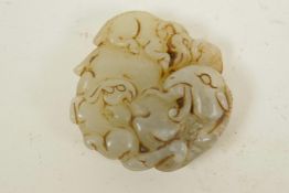 A Chinese hardstone pendant carved as a goat and elephant, 2" diameter