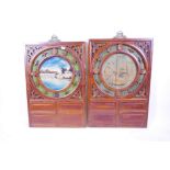A pair of Chinese carved wood panels with painted roundels of lake and landscape scenes, 25" x 36"