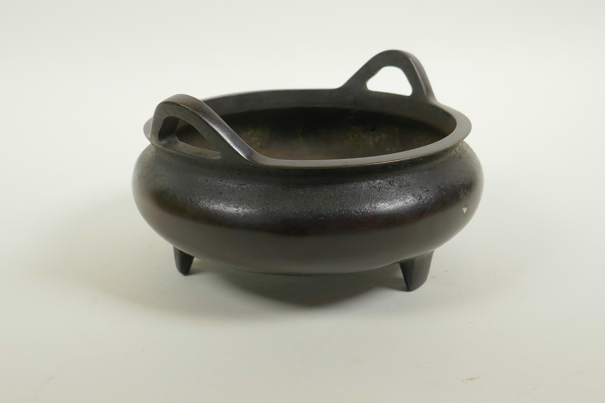 A Chinese bronze censer on tripod supports with phoenix eye handles, impressed seal mark to base, 7" - Image 2 of 3