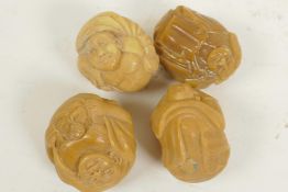Four carved tagua nut carved figures and mythical beasts, 1" diameter