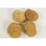 Four carved tagua nut carved figures and mythical beasts, 1" diameter