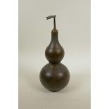 A Chinese bronze bottle in the form of a double gourd, impressed Yin Yang mark to base, 12" high