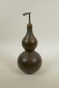 A Chinese bronze bottle in the form of a double gourd, impressed Yin Yang mark to base, 12" high