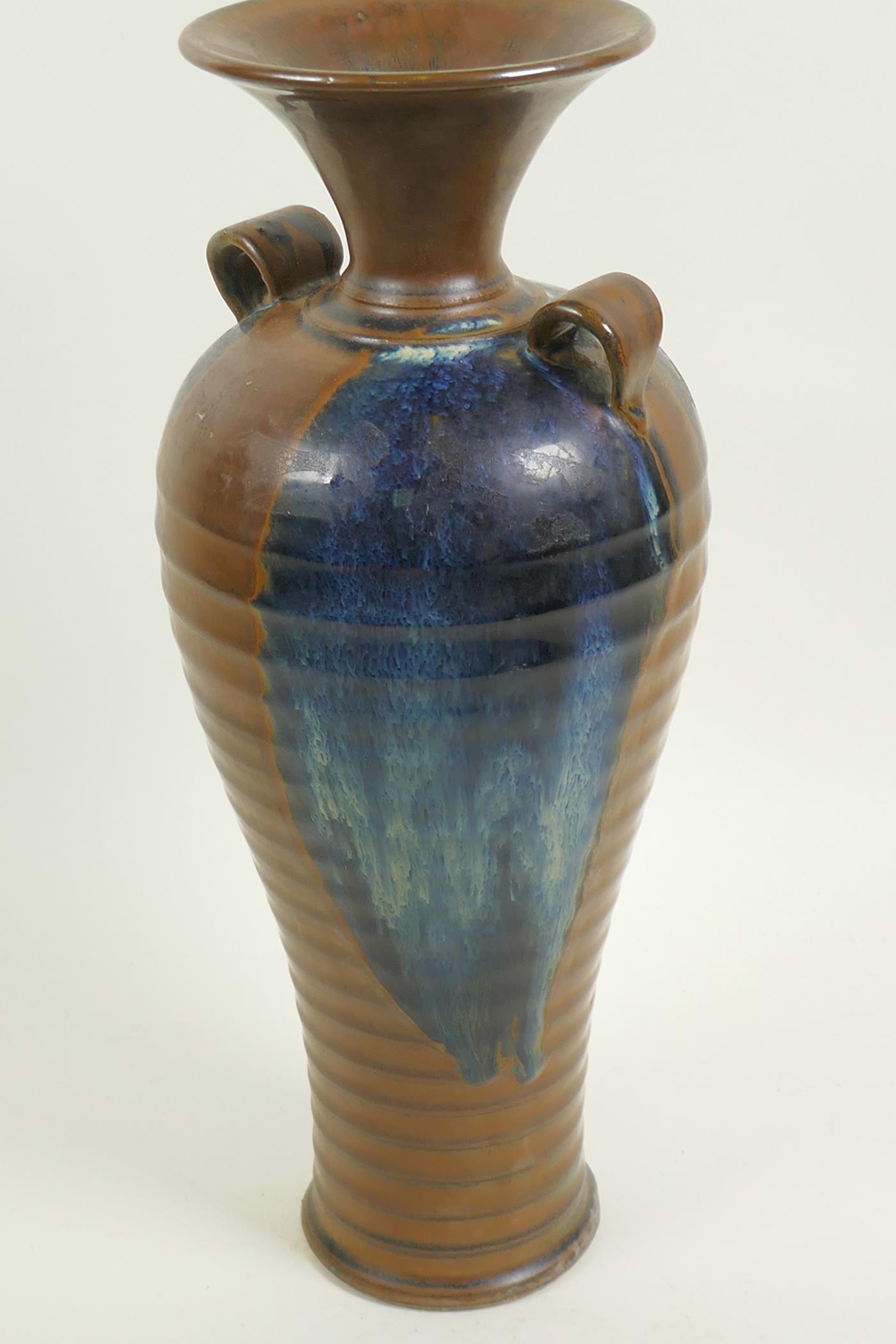 A Chinese stoneware baluster vase with rib formed body and two loop handles, drip glazed in brown - Image 4 of 4