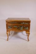 A Chinese gilt lacquer lowboy, with four drawers and carved and painted decoration, raised on