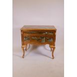 A Chinese gilt lacquer lowboy, with four drawers and carved and painted decoration, raised on