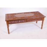 An Oriental carved hardwood low table with two frieze drawers, 22" x 49" x 19"
