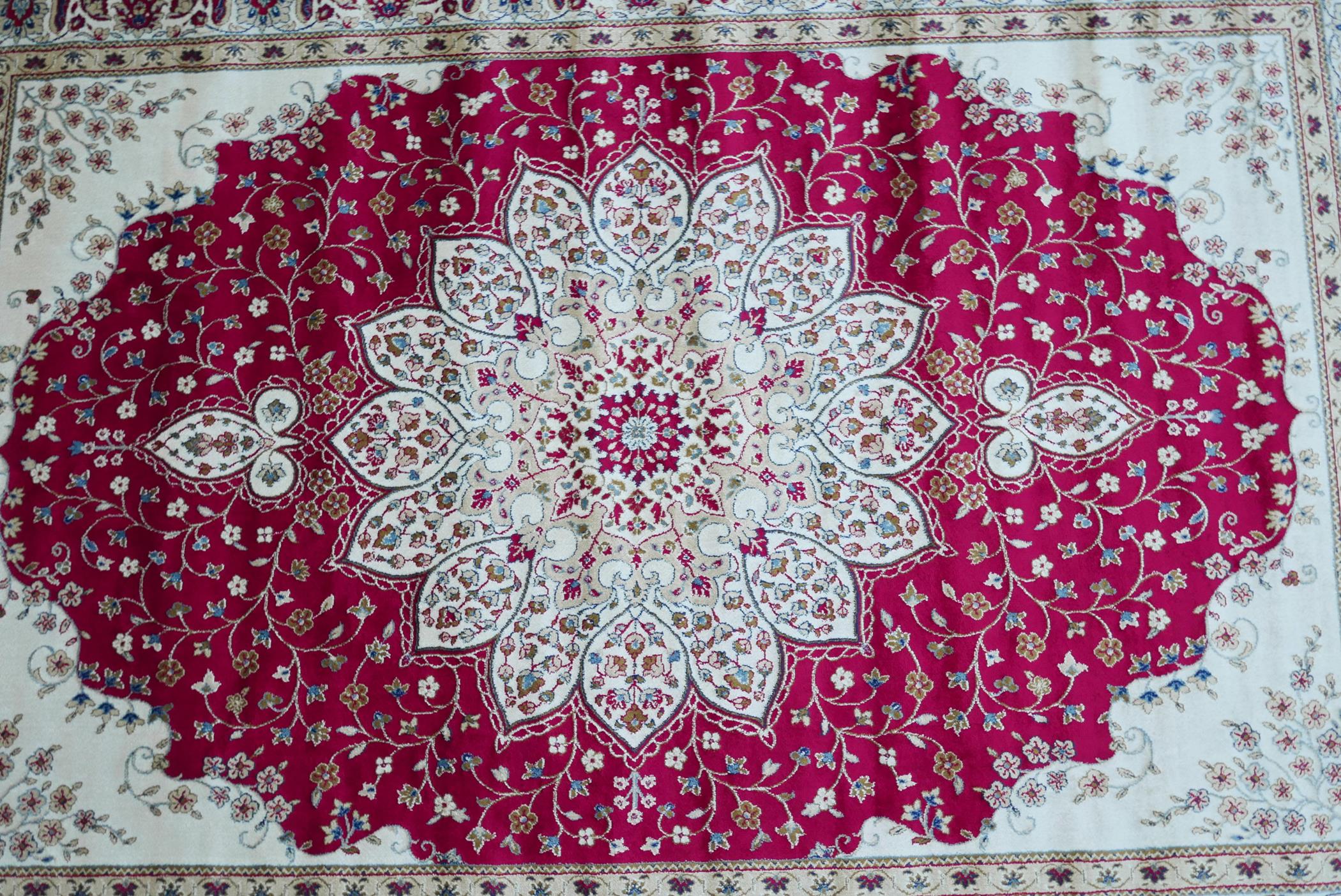 A Kashmiri red ground rug with an unique floral medallion design, 61½" x 91" - Image 3 of 5