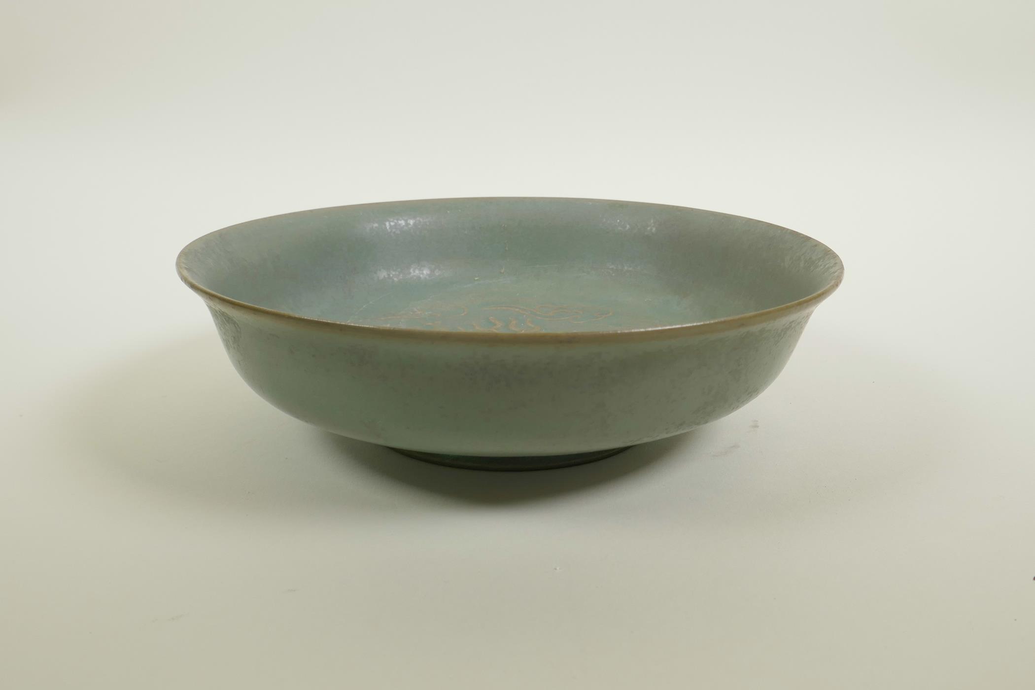 A Chinese Song style celadon glazed porcelain bowl with raised kylin and flaming pearl decoration to - Image 2 of 3