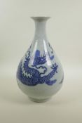 A Chinese blue and white porcelain pear shaped vase decorated in the Ming style depicting dragons