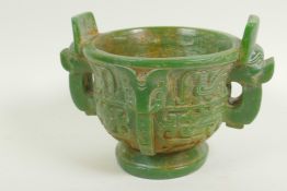 A Chinese carved green hardstone censer with two mask handles on pedestal base carved with birds and