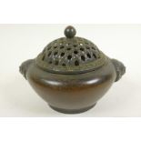 A Chinese bronze incensor with lion mask handles and pierced basket pattern cover, 4½" diameter