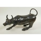 A Chinese bronze figure of a bull, 11½" long