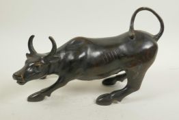 A Chinese bronze figure of a bull, 11½" long