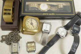 Seven various wristwatches and a small brass cased travel clock