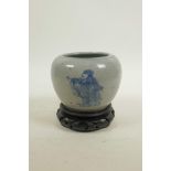 A Chinese blue and white crackle ware pot decorated with immortals, on a carved hardwood stand, 5"