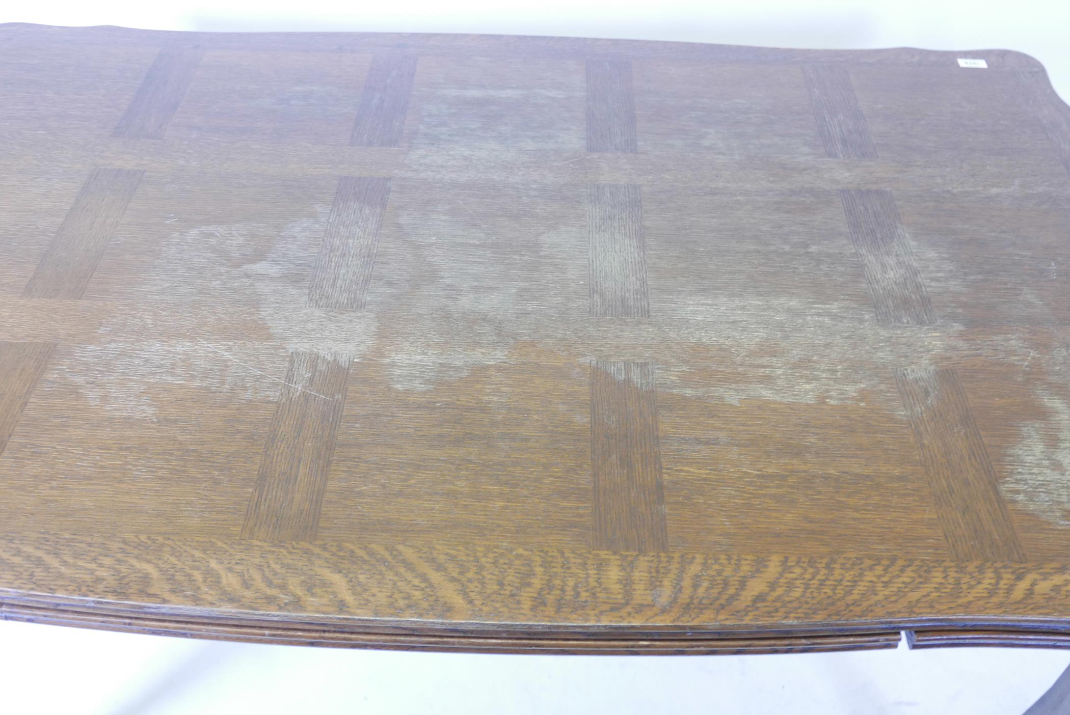 A French oak drawleaf dining table, with parquetry veneered top and pull out leaves, raised on - Image 2 of 4