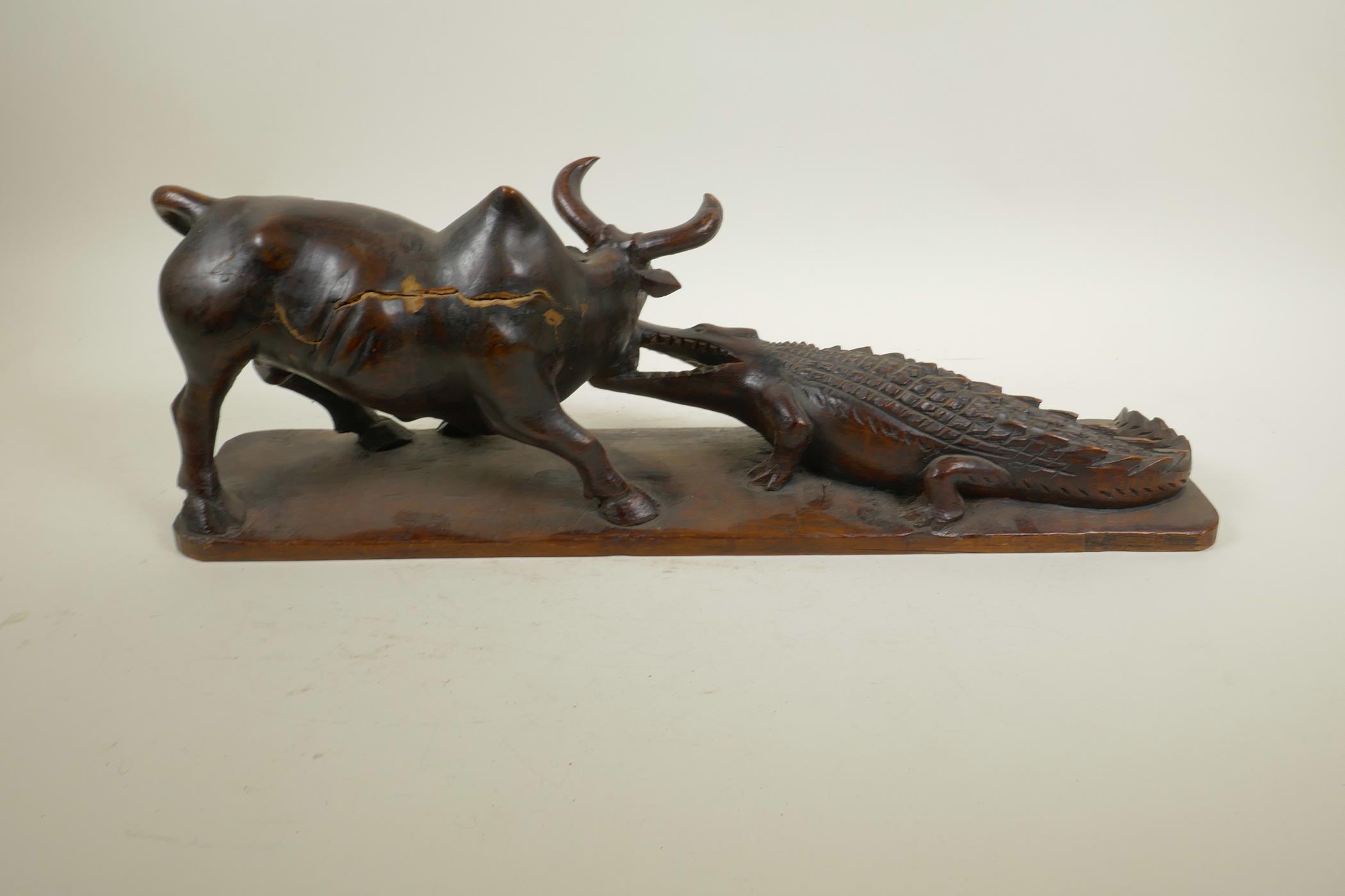 An African carved hardwood figure group decorated with a crocodile attacking a buffalo, 20½" long, - Image 5 of 6