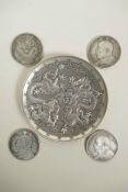 A Chinese white metal coin dish with raised dragon decoration, and four facsimile (replica)