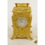 A Rococo style gilt cased miniature carriage clock with key, 3" high