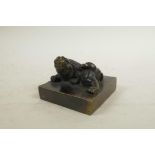 A Chinese filled bronze seal, the surmount in the form of a temple lion, 3" x 3"