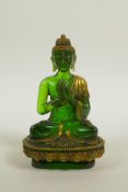 A green Peking glass Buddha seated in meditation on a lotus flower, with gilt highlights, 5" high