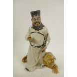 A Chinese, Shiwan style, mud men figure of a man with a tiger at his feet, 12" high